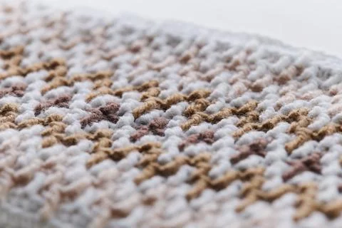 Macro close-up of brown mosaic crochet cosmetic bag texture with shallow depth 库存照片