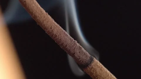Macro Close Up of Burning Incense Stick with Rising Smoke Against Black Stock Footage 340798689