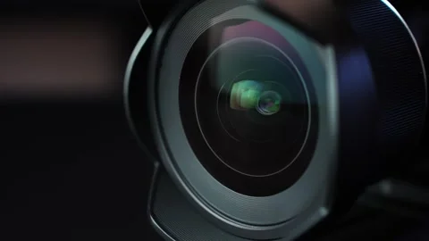 Macro close-up of camera lens as aperture blades move during power-on, with Stock Footage 328974851