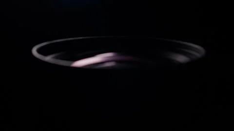 Macro Close Up of Camera Lens with Pink Reflection on Black Background Stock Footage 340471926