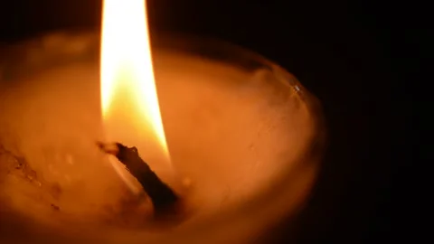 Macro close-up candle with red flame fire blown out in a black background 스톡 동영상 197797502