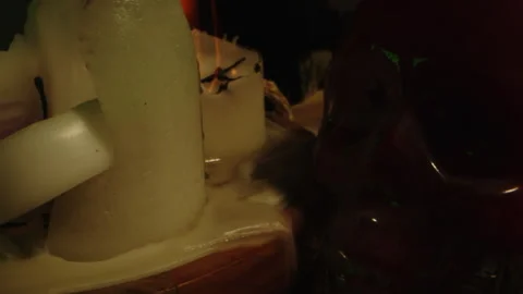 Macro close up of candles, panning towards a blood filled glass skull on the Stock Footage 336004488