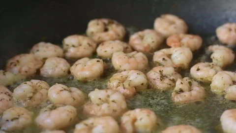 Macro close up chef frying shrimps at home - 8s Stock Footage 128844174