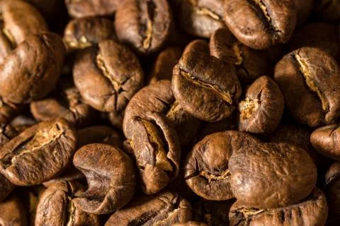 Macro close up of coffee beans on a black background Stock Photos