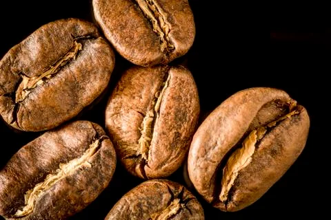 Macro close up of coffee beans on a black background Stock Photos