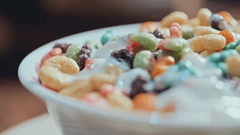 Macro Close Up of Colorful Cereal with Milk in White Bowl Stock Footage 335895280