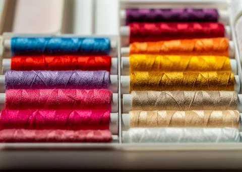 Macro close up of colorful sewing thread spools in variety of vibrant shade.. Stock Photos
