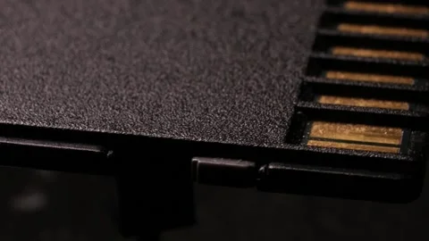 Macro close up of computer sd flash memory card rotating around Video stock 104053637