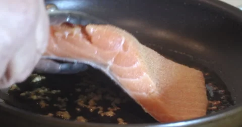 Macro Close Up of Cooking Salmon in Garlic and Butter in Cast Iron Pan Stock Footage 262101726