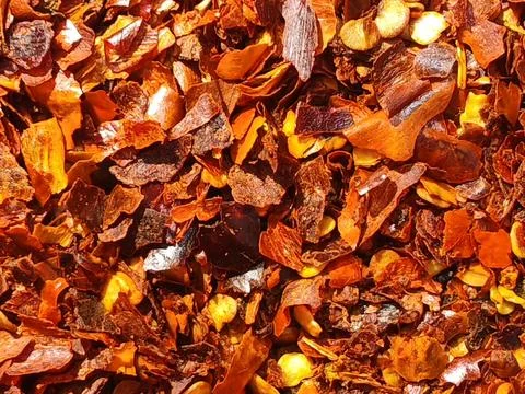 Macro close-up of crushed red pepper flakes with seeds, spicy chili seasonin Stock Photos