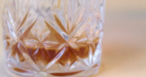 Macro Close Up of Dark Amber Whiskey Being Poured Into Glass Stock Footage 261803749