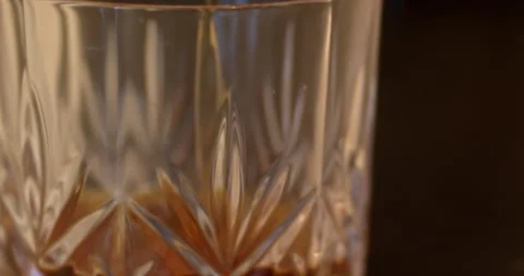 Macro Close Up of Dark Amber Whiskey Being Poured Into Glass Stock Footage 261804442