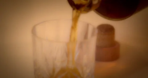 Macro Close Up of Dark Amber Whiskey Being Poured Into Glass, Soft Focus Stock Footage 261805222