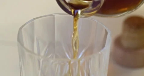 Macro Close Up of Dark Amber Whiskey Being Poured Into Glass Stock Footage 261806755