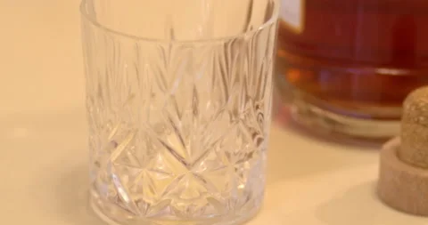 Macro Close Up of Dark Amber Whiskey Being Poured Into Glass Stock Footage 261807363