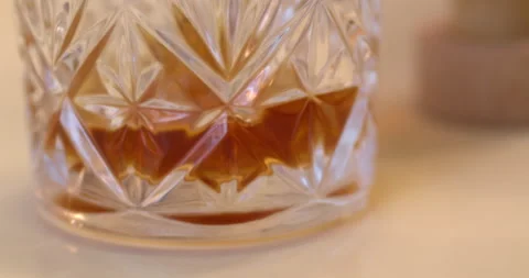 Macro Close Up of Dark Amber Whiskey Being Poured Into Glass Stock Footage 261812494