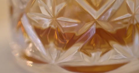 Macro Close Up of Dark Amber Whiskey Being Poured Into Glass Stock Footage 261812912