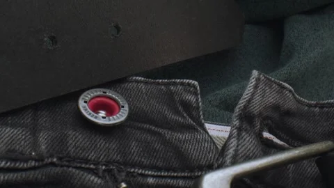 Macro close up of a dark leather belt and a pair of jeans. Slow motion Stock Footage 240848946