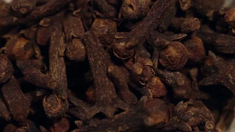 Macro close up dolly past white bowl of cloves Stock Footage 156455946