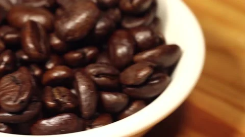 Macro close up dolly past white bowl of coffee beans Stock Footage 156460462
