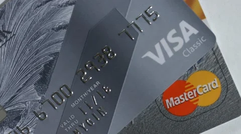 Macro close up dolly shot of  two major credit cards Visa and MasterCard over Video stock 60332533