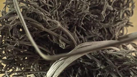 Macro close up of dried rosemary herb showcasing aromatic texture on wooden Stock Footage 340193115