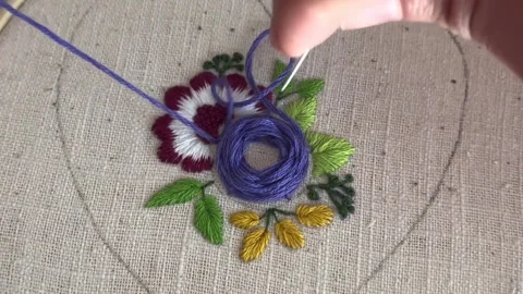 Macro close up of embroidery stitches on fabric, purple thread Stock Footage 335193845