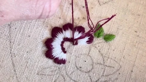 Macro close up of embroidery stitches on linen fabric, decorative knot Stock Footage 335193795