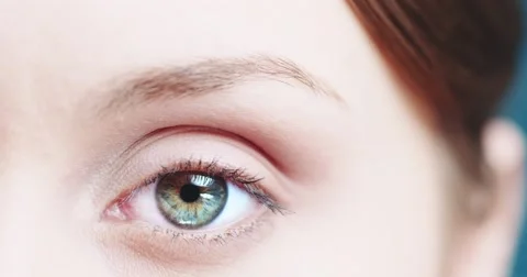 Macro Close-up eye blinking. Young Woman is opening and closing beautiful eye. Stock Footage 53815766