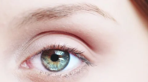 Macro Close-up eye blinking. Young Woman is opening and closing beautiful eye. Stock Footage 53815836