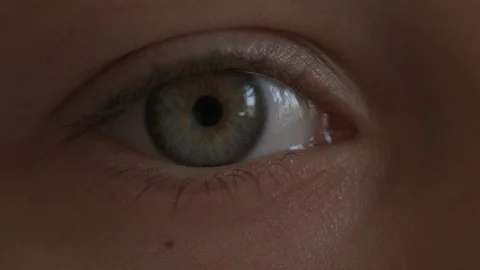 Macro Close-up eye blinking. Young girl is opening and closing her beautiful Stock Footage 94050039
