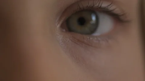 Macro Close-up eye blinking. Young girl is opening and closing her beautiful Stock Footage 94050047