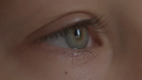 Macro Close-up eye blinking. Young girl is opening and closing her beautiful Stock Footage 94050080