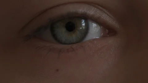 Macro Close-up eye blinking. Young girl is opening and closing her beautiful Stock Footage 94050094