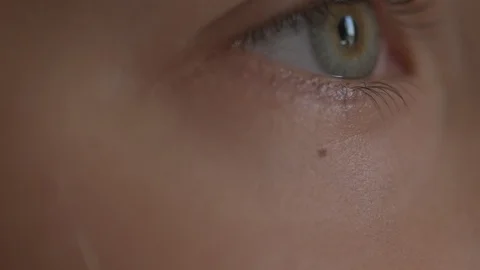 Macro Close-up eye blinking. Young girl is opening and closing her beautiful Stock Footage 94050106