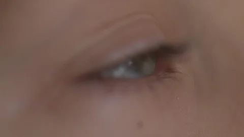 Macro Close-up eye blinking. Young girl is opening and closing her beautiful Stock Footage 94050138