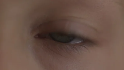 Macro Close-up eye blinking. Young girl is opening and closing her beautiful Stock Footage 94050153