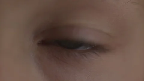 Macro Close-up eye blinking. Young girl is opening and closing her beautiful Stock Footage 94050183