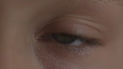 Macro Close-up eye blinking. Young girl is opening and closing her beautiful Stock Footage 94050193