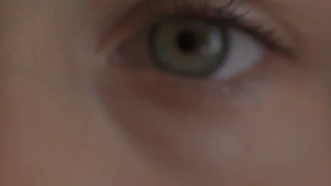 Macro Close-up eye blinking. Young girl is opening and closing her beautiful Stock Footage 94050202