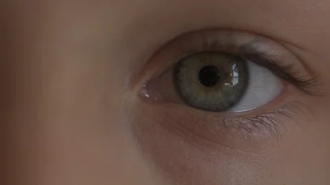 Macro Close-up eye blinking. Young girl is opening and closing her beautiful Stock Footage 94050251