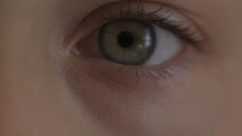 Macro Close-up eye blinking. Young girl is opening and closing her beautiful Stock Footage 94050255