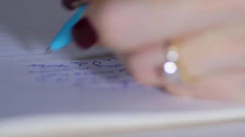 Macro close up of female hand writing in notepad with pen 2 Stock-Footage 70243113