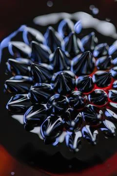 Macro close-up of ferrofluid. Red and blue. Stock Photos