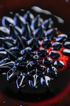 Macro close-up of ferrofluid. Red and blue. Stock Photos