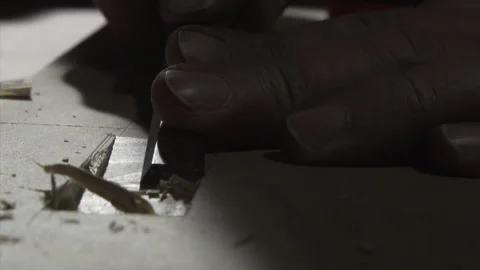 Macro close-up of fingers guiding a chisel to clean a mortise (part 1) Video stock 346253995