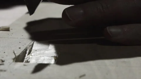 Macro close-up of fingers guiding a chisel to clean a mortise (part 2) Stock Footage 346254126