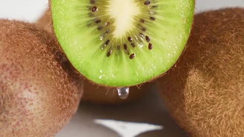 Macro Close Up of Fresh Kiwi Slice Dripping Water Drop Stock Footage 340934747