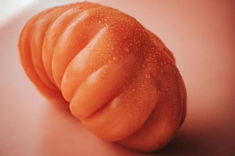 Macro close-up of a fresh red ribbed heirloom tomato. Stock Photos
