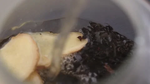 Macro close-up ginger tea. Natural hot drink for health and wellness Stock Footage 318482198